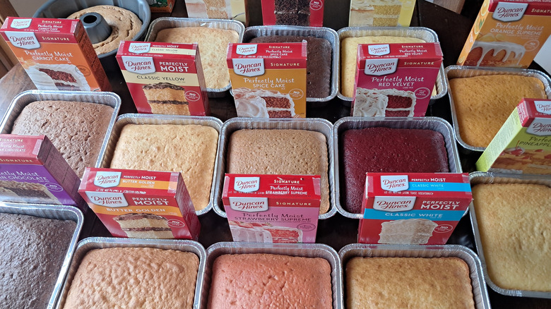 multiple baked Duncan Hines cakes and their boxes