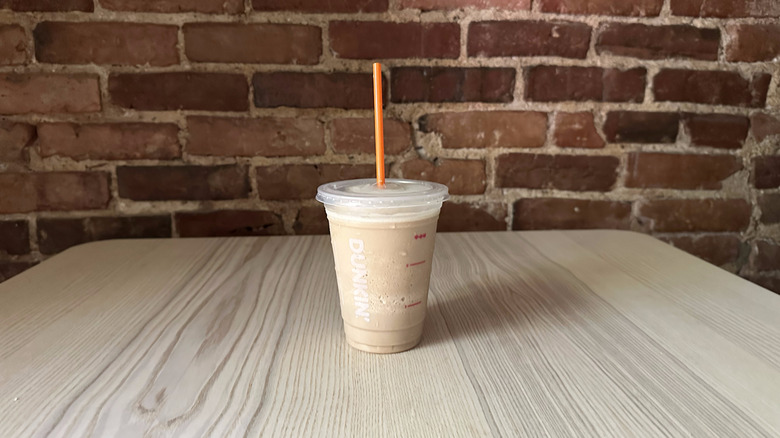 Dunkin Coffee Chiller sitting on a table in front of a brick wall