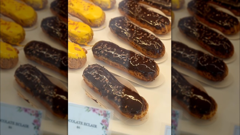 multiple eclairs in a display case at Artelice Patisserie