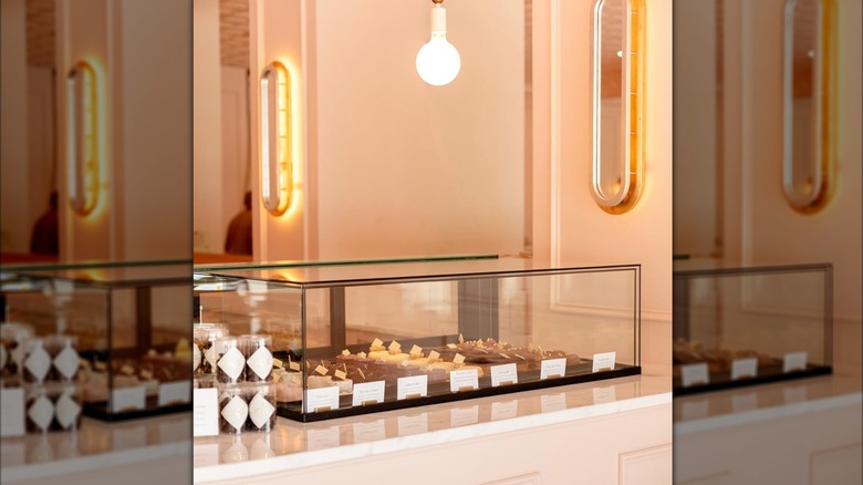 display case at Sucre bakery which contains different flavors of eclairs