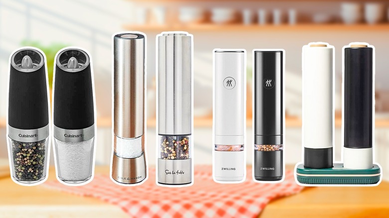 Variety of electric salt and pepper grinders against kitchen background