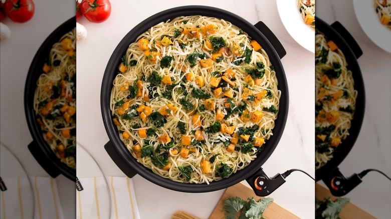 A DASH electric skillet with pasta