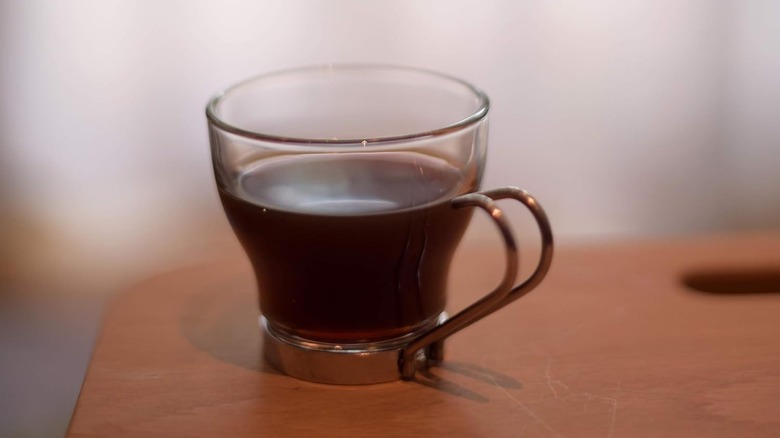 Close-up of a Bormioli Rocco espresso cup on a desk with espresso inside