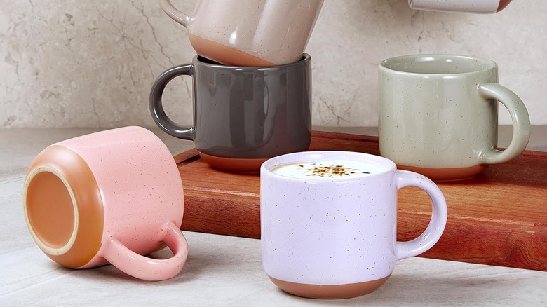 Selection of Morandi espresso cups scatted around a chopping board, with one full of coffee