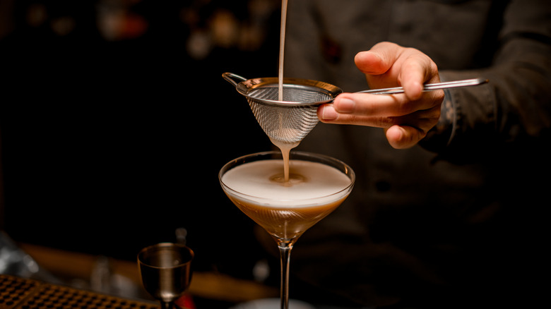 Espresso Martini being poured into a cocktail glass