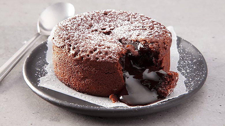 Domino's chocolate lava cake on plate, with chocolate sauce oozing out