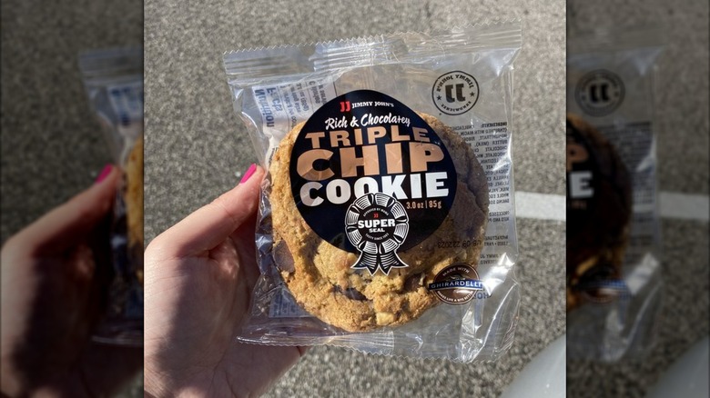 Hand holding packaged Triple Chip Cookie from Jimmy John's