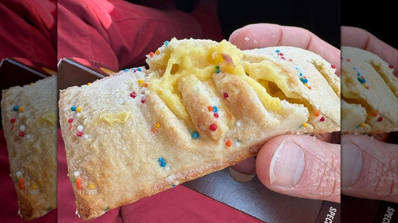 Hand holding McDonald's custard-filled Holiday Pie