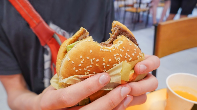 person holding a fast food burger