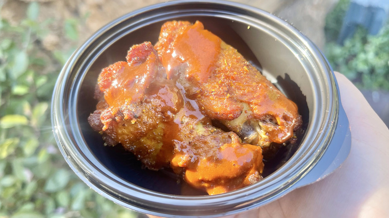 Close-up of Tajín Habanero Seasoned Wings in a black dish