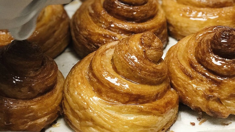 Shiny cinnamon rolls on tray
