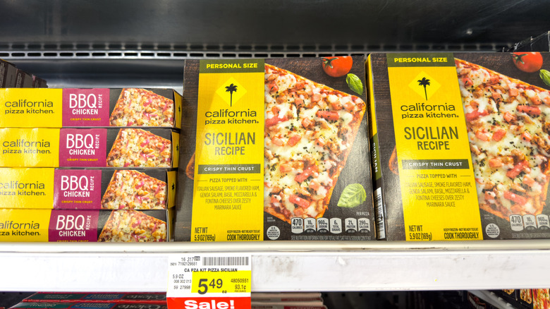 different boxes of California Pizza Kitchen pies in the freezer