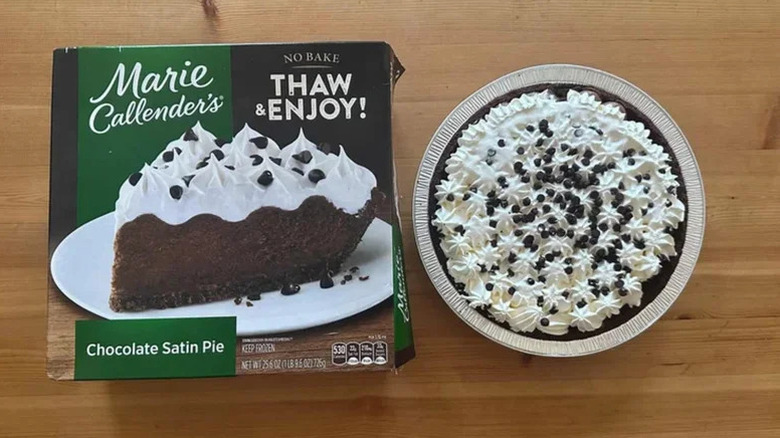A Marie Callender's Chocolate Satin Pie box on a table next to the frozen pie