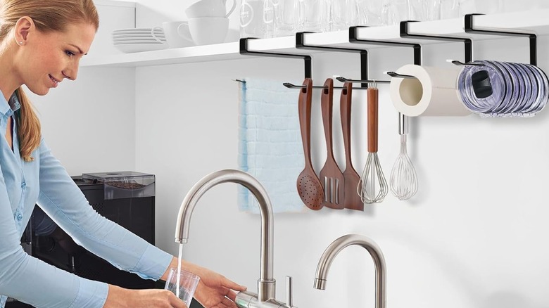 Tumbler lids and utensils on Jolensoy tumbler lid organizer above a sink