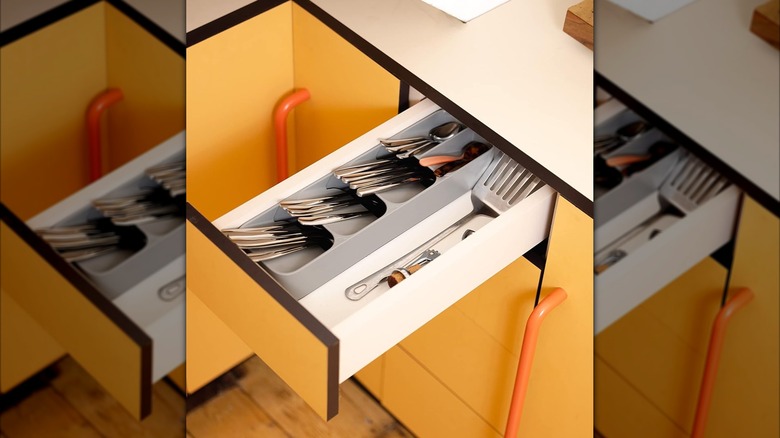 A Joseph Joseph compact utensil organizer in a narrow drawer