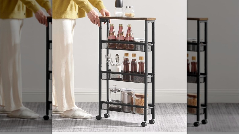 A person pushing a Vasagle slim rolling cart