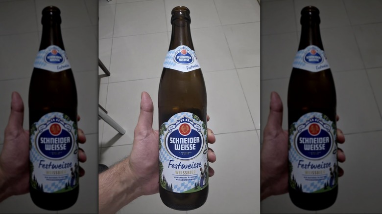 Hand holding a bottle of Schneider Weisse Festweisse