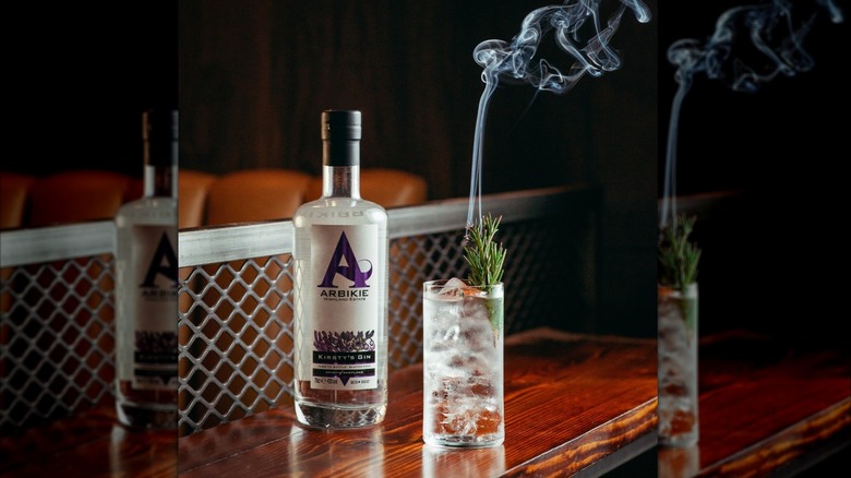 Bottle of Arbikie Kirsty's Gin next to a smoking G&T