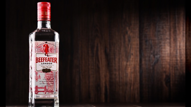 Bottle of Beefeater London Dry gin against a wooden backdrop