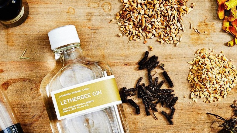 Bottle of Letherbee Original Label Gin with some of its botanicals