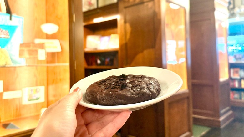 chocolate cookie being held up in the Drama Book Shop