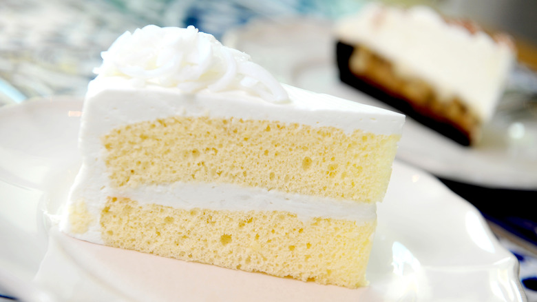 yellow slice of cake with chocolate cake behind