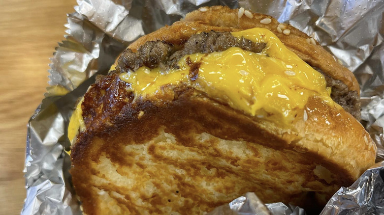 A close-up of a Five Guys grilled cheese with burger patty
