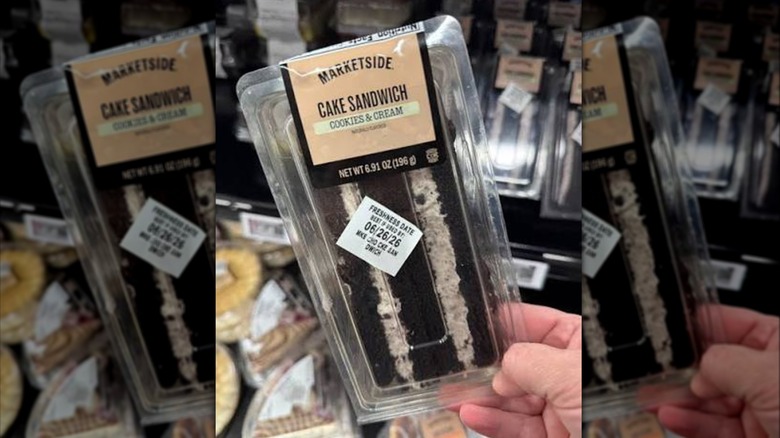 A hand holding a Marketside Cake Sandwich
