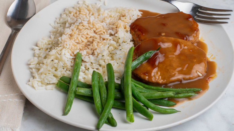 Salisbury steak with sides of rice and green beans