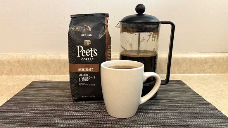 Peet's Major Dickason's blend coffee in bag, cup, and french press on black placemat