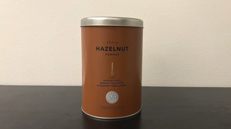 Coffee bean and tea leaf hazelnut powder can on table