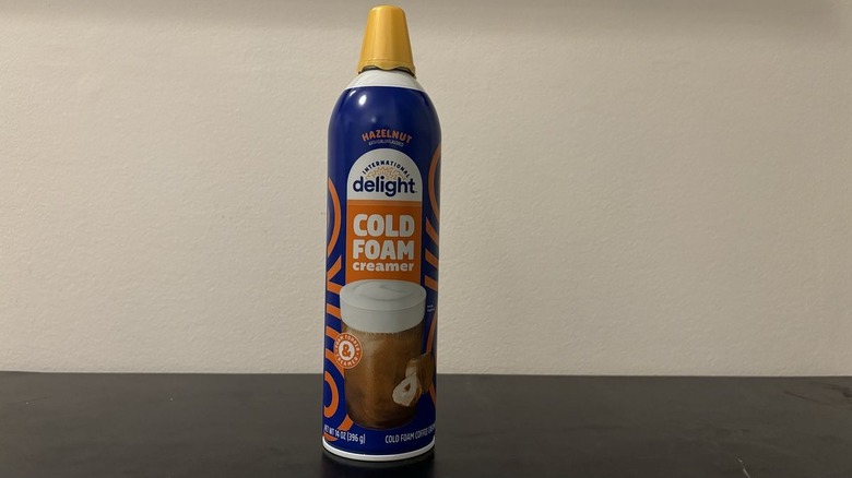 International Delight hazelnut cold foam can on table