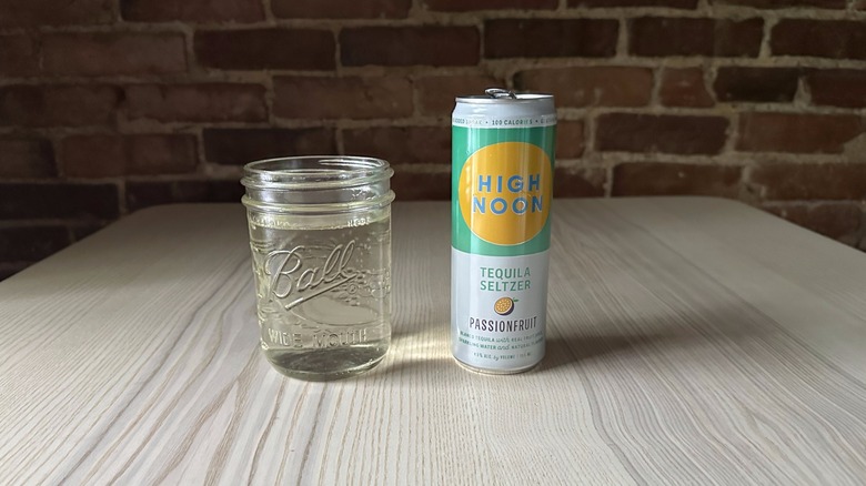 High Noon Passionfruit seltzer can and glass