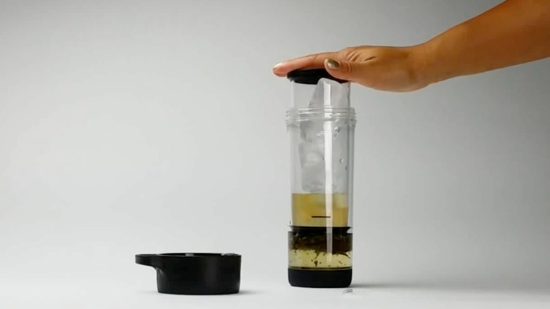 A person holding a Primula Press & Go Iced Tea Brew Tumbler