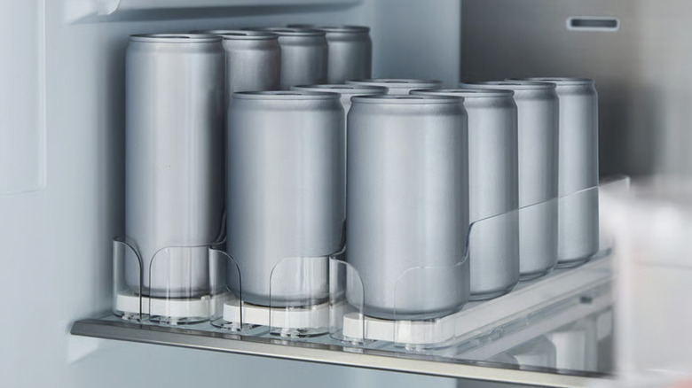 Tall and short soda-type cans in fridge drink holders