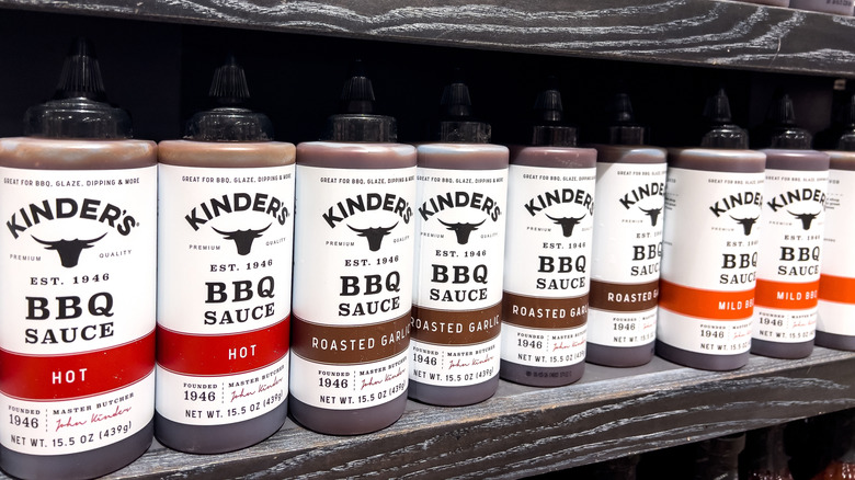 A row of Kinder's BBQ sauces on a shelf at a store