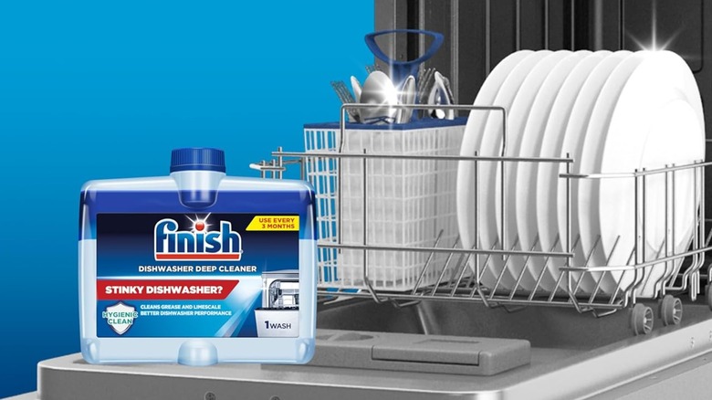 Finish Dishwasher Cleaner Liquid sitting on an open dishwasher door with clean dishes