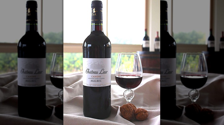 Bottle and glass of Château Laur Prestige Malbec