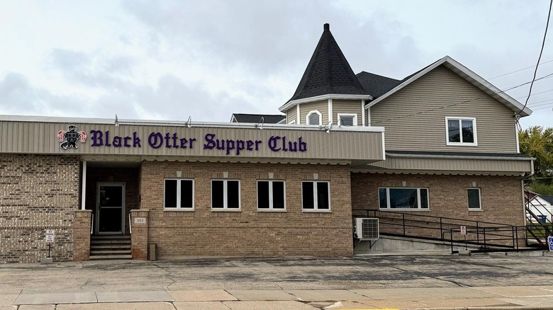 A brown walled restaurant with "Black Otter Supper Club"