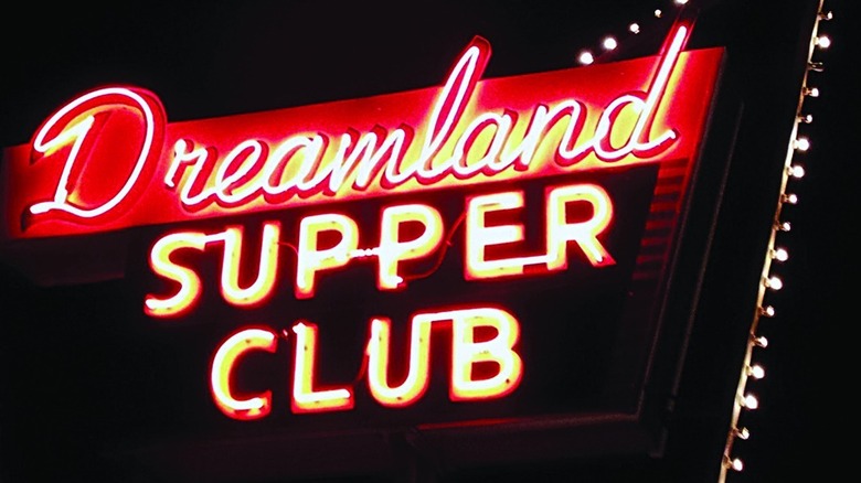 A neon restaurant sign stating "Dreamland Supper Club"