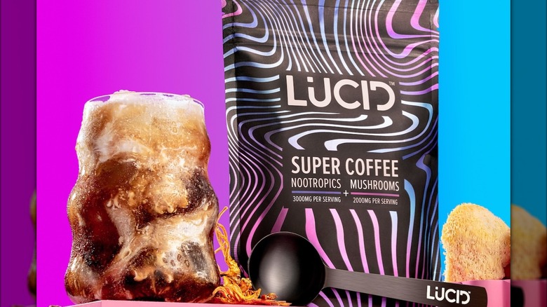 Pack of Lucid coffee with scoop and glass of iced coffee with milk