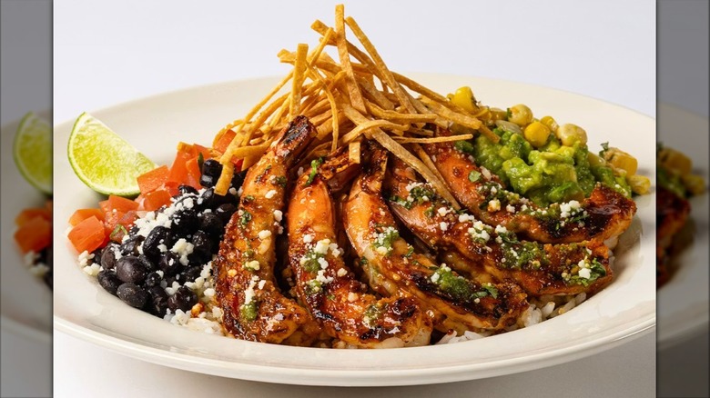 Chipotle-Honey Shrimp Baja Bowl from the Cheesecake Factory on white plate with lime wedge