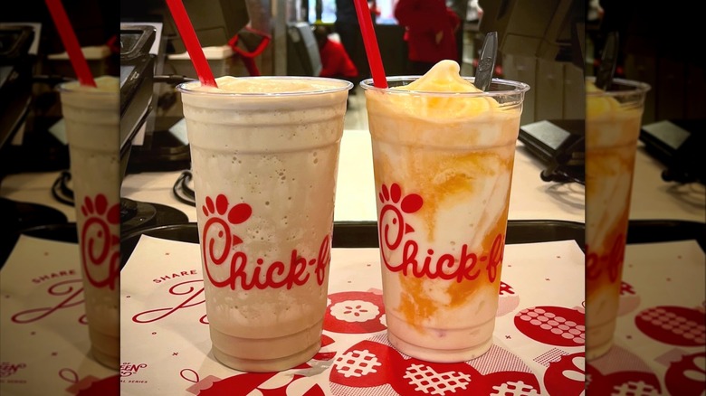 Two Chick-fil-A Frosted Sodas sitting on patterned paper placemat