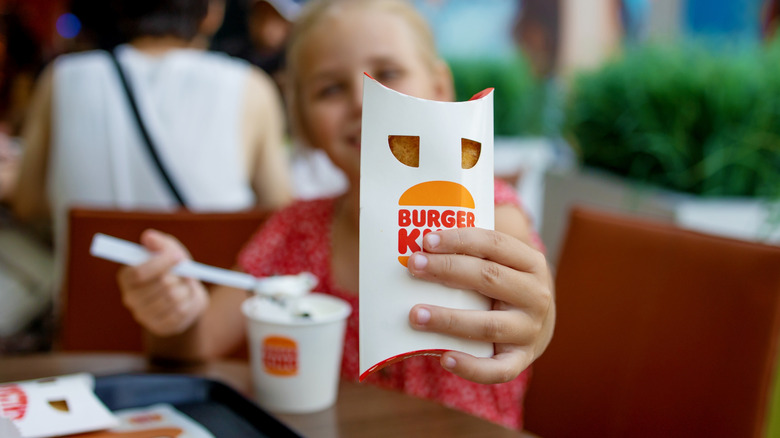 child holding pie and eating ice cream at Burger King