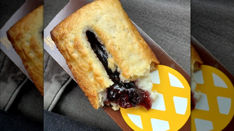 McDonald's Blueberry & Crème Pie cut in half on top of cardboard box