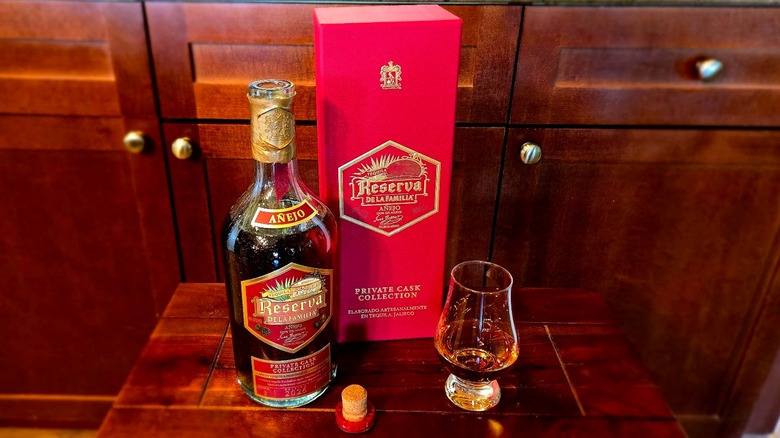 Bottle of Reserva de la Familia Mole Cask Anejo Tequila with glass and box
