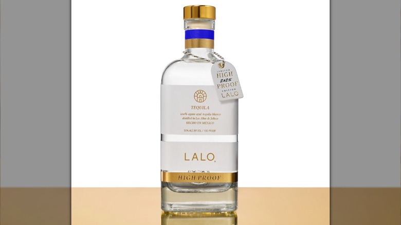 Bottle of Lalo Blanco high-proof tequila on table in front of white background