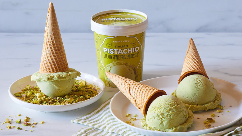 A pint of Italian Pistachio Gelato Style Frozen Dessert next to plates of ice cream cones