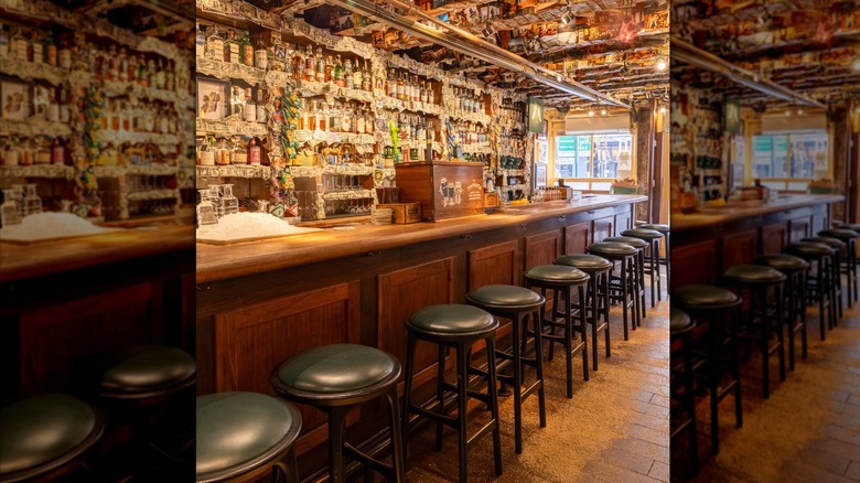 Bar and stools with wall of bottles