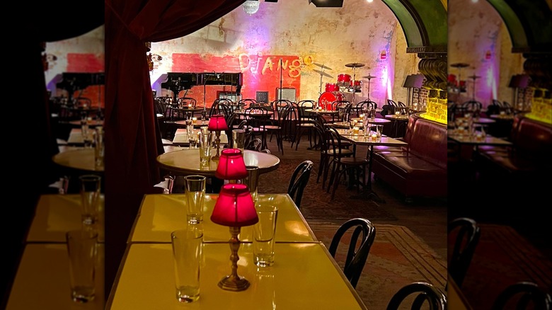 Tables with red lights looking toward a stage in the background